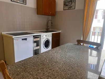 a kitchen with a sink and a washing machine at Domus Ele in Rome