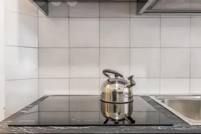a tea kettle sitting on a stove in a kitchen at La Casetta Furio Camillo in Rome
