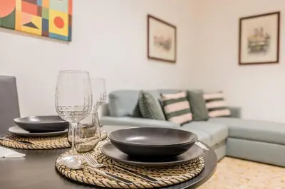 a table with two plates and glasses on it at La Casetta Furio Camillo in Rome