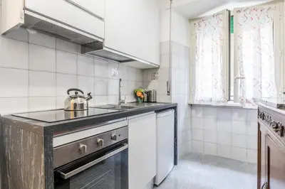 a kitchen with a sink and a stove at La Casetta Furio Camillo in Rome