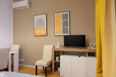 a room with a desk with a television and a chair at Toto Vatican Suite in Rome