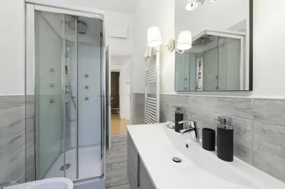 a bathroom with a shower and a sink and a mirror at Toto Vatican Suite in Rome