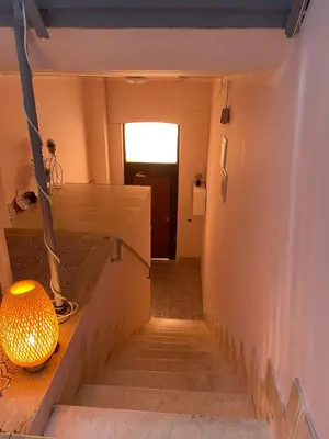 a set of stairs with a lamp and a hallway at Ines Guest House in Rome