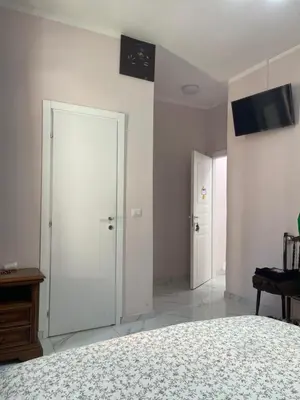 a bedroom with a bed and two white doors at Ines Guest House in Rome