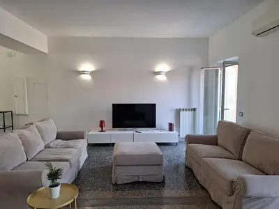 a living room with two couches and a tv at Monti View Apartment in Rome