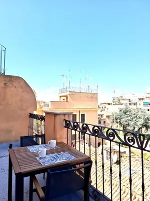 a table on a balcony with a view of a city at Monti View Apartment in Rome