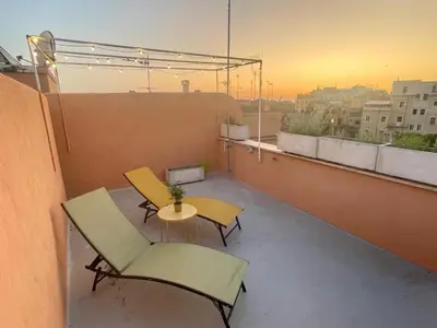 a balcony with a table and chairs on a building at Monti View Apartment in Rome