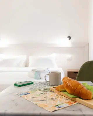 a table with a loaf of bread and a coffee cup at Rental in Rome Guest House 2-ZEN51 in Rome