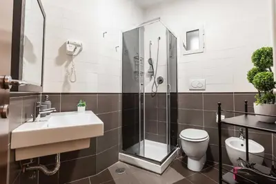 a bathroom with a shower and a sink and a toilet at Rental in Rome Guest House 2-ZEN51 in Rome