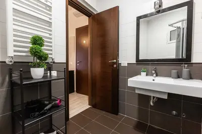 a bathroom with a sink and a mirror at Rental in Rome Guest House 2-ZEN51 in Rome