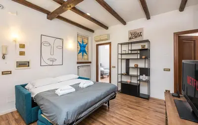 a bedroom with a bed and a television at Vaticano-Metro A 1 min, Urban Rooftop in Rome