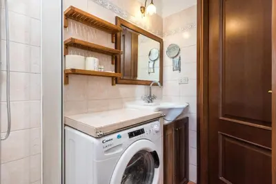 a small bathroom with a washing machine and a sink at Vaticano-Metro A 1 min, Urban Rooftop in Rome