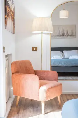 a living room with a chair and a bed at Vaticano-Metro A 1 min, Urban Rooftop in Rome
