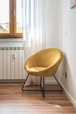 a yellow chair in a room with a window at Vaticano-Metro A 1 min, Urban Rooftop in Rome