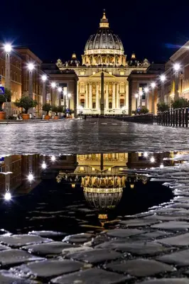 a building with a reflection in the water at night at Vaticano-Metro A 1 min, Urban Rooftop in Rome
