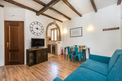 a living room with a blue couch and a table at Vaticano-Metro A 1 min, Urban Rooftop in Rome