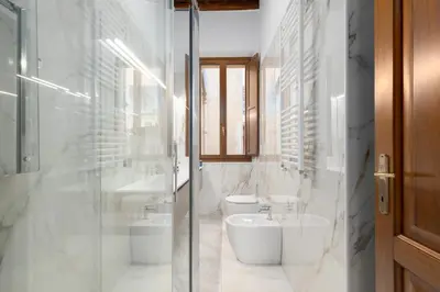 a bathroom with two toilets and a sink at Elegant Prefetti Home in Rome
