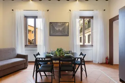 a living room with a table and chairs and a couch at Elegant Prefetti Home in Rome