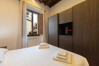 a bedroom with a bed with two towels on it at Elegant Prefetti Home in Rome