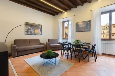 a living room with a couch and a table and chairs at Elegant Prefetti Home in Rome