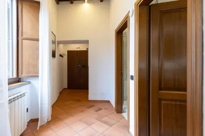 a hallway with a door and a tile floor at Elegant Prefetti Home in Rome