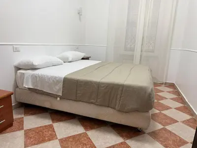 a bed in a bedroom with a checkered floor at GranRoma in Rome