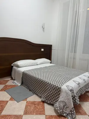 a bedroom with a large bed and a dresser at GranRoma in Rome