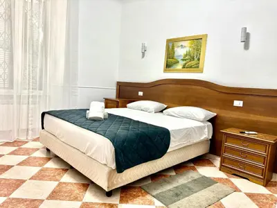 a bedroom with a large bed with a window at GranRoma in Rome