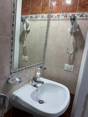 a bathroom with a white sink and a mirror at GranRoma in Rome