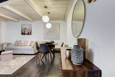 a living room with a couch and a table at Trastevere Piazza Trilussa Royal Orchid apartment in Rome