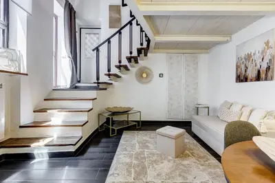 a living room with stairs and a couch at Trastevere Piazza Trilussa Royal Orchid apartment in Rome