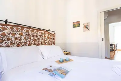 a bedroom with a white bed with a wooden tray on it at Belle Arti Zen Apartment- Cale 03 in Rome