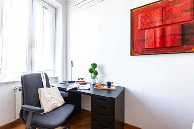 a black desk with a chair in a room at Belle Arti Zen Apartment- Cale 03 in Rome