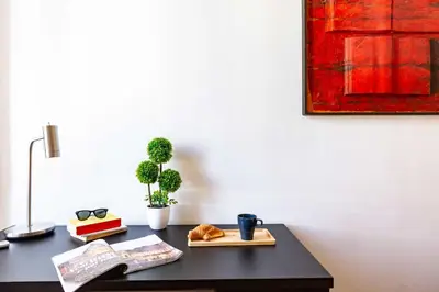 a black desk with a book and a lamp and a book at Belle Arti Zen Apartment- Cale 03 in Rome