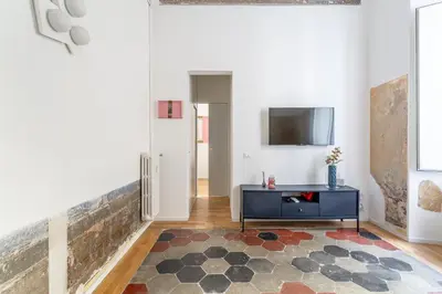 a living room with a blue table and a tv at iFlat New Boutique Apartment in Rome's Heart in Rome