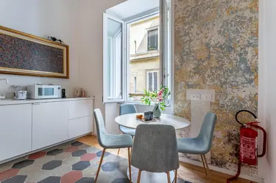 a room with a table and chairs and a window at iFlat New Boutique Apartment in Rome's Heart in Rome