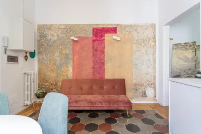 a living room with a couch in front of a wall at iFlat New Boutique Apartment in Rome's Heart in Rome