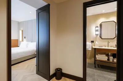 a bedroom with a bed and a bathroom with a mirror at Circle6 Rome in Rome