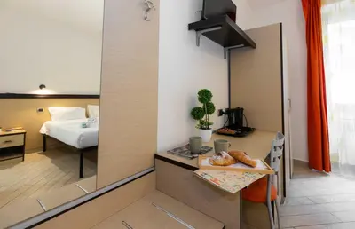 a room with a bed and a table with a tray of donuts at Rental in Rome Guest House - ZEN01 in Rome