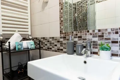 a bathroom with a white sink and a mirror at Rental in Rome Guest House - ZEN01 in Rome