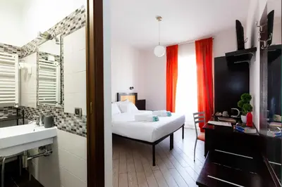 a bedroom with a bed and a bathroom with a sink at Rental in Rome Guest House - ZEN01 in Rome