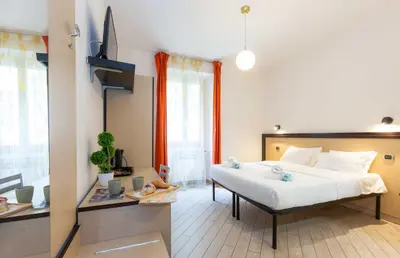 a bedroom with a large white bed in a room at Rental in Rome Guest House - ZEN01 in Rome