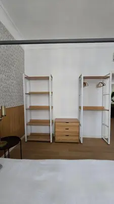 a bedroom with white shelves and a bed at Aeterna Suites Roma in Rome
