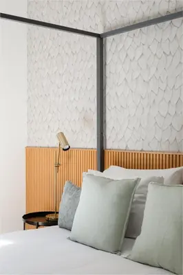 a bedroom with a bed with white pillows at Aeterna Suites Roma in Rome
