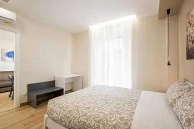 a bedroom with a bed and a painting on the wall at Aurelius Design Loft 1 in Rome