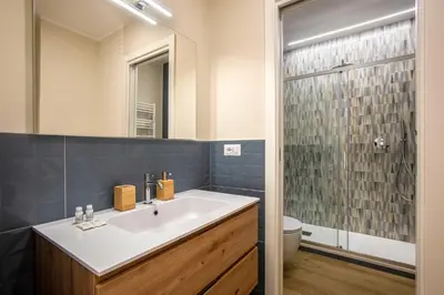 a bathroom with a sink and a toilet and a mirror at Aurelius Design Loft 1 in Rome