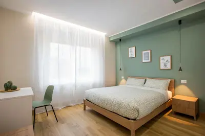a bedroom with a bed and a desk and a window at Aurelius Design Loft 2 in Rome