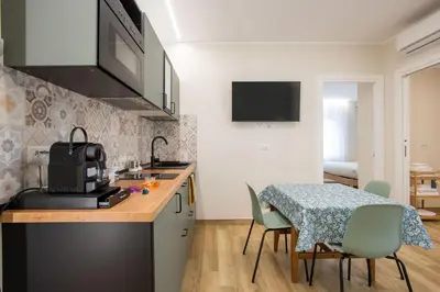 a kitchen with a table and chairs and a dining room at Aurelius Design Loft 2 in Rome