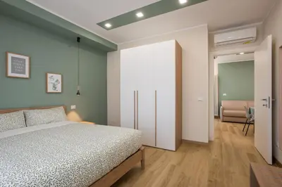 a bedroom with a bed and a room with a couch at Aurelius Design Loft 2 in Rome