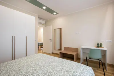 a bedroom with a bed and a desk and a chair at Aurelius Design Loft 2 in Rome